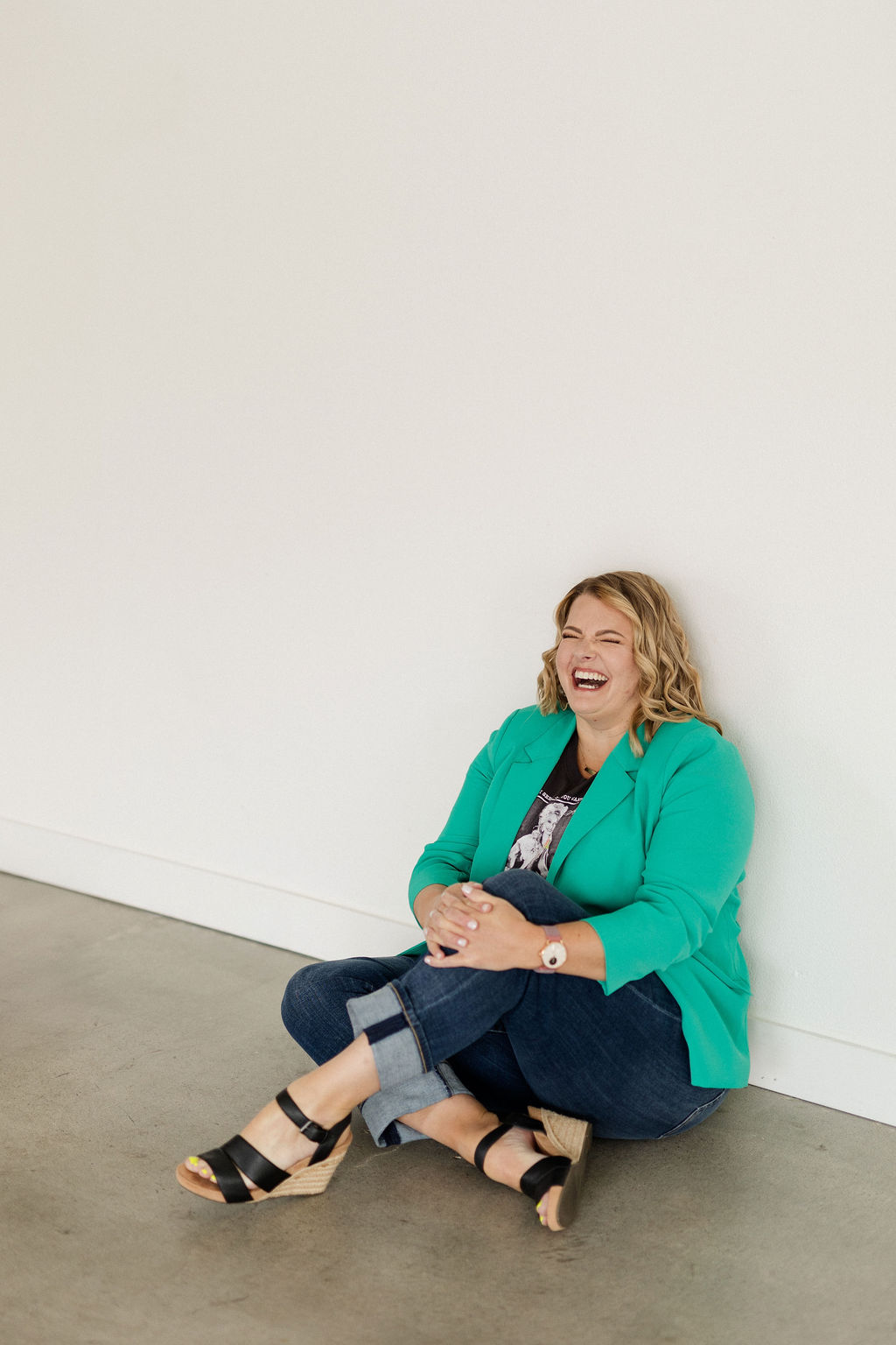 Photo of Lynn Marie Debilzen, founder of The Collective Shift Co., smiling and making a fun face